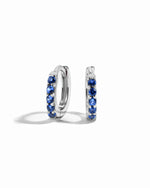 Gemstone earrings sterling silver sapphire birthstone cz huggies on white background.
