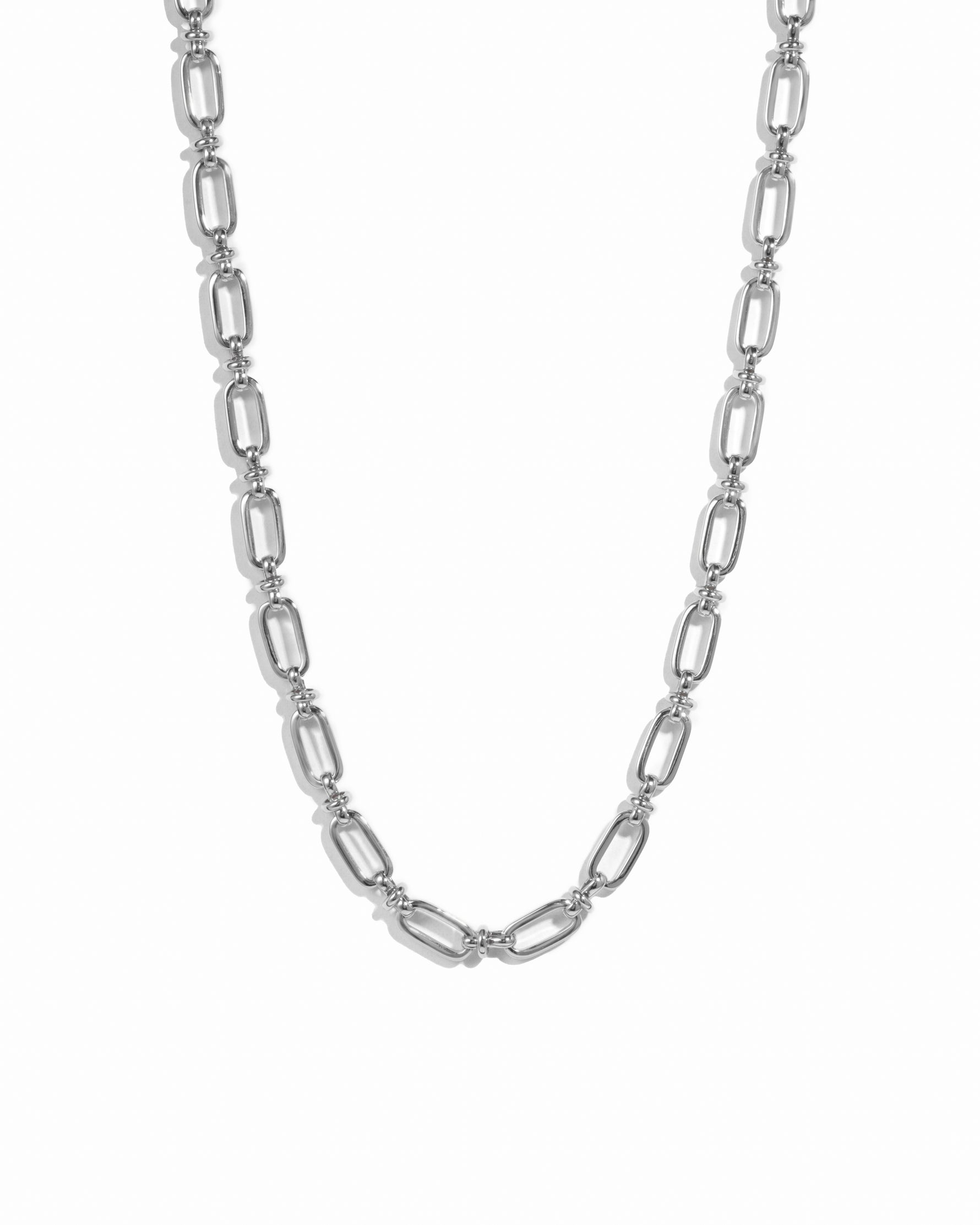 Silver statement chain link necklace on white background.
