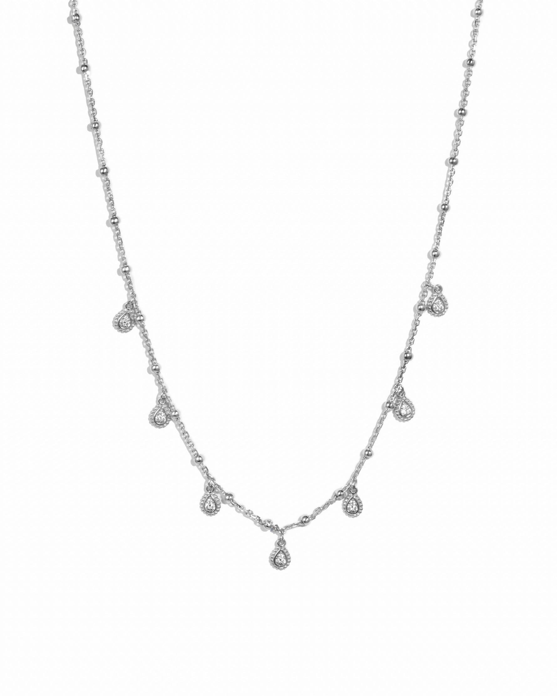 Sterling silver tear drop beaded charm necklace on white background.