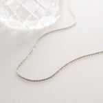 Silver diamond cut necklace in soft white lighting