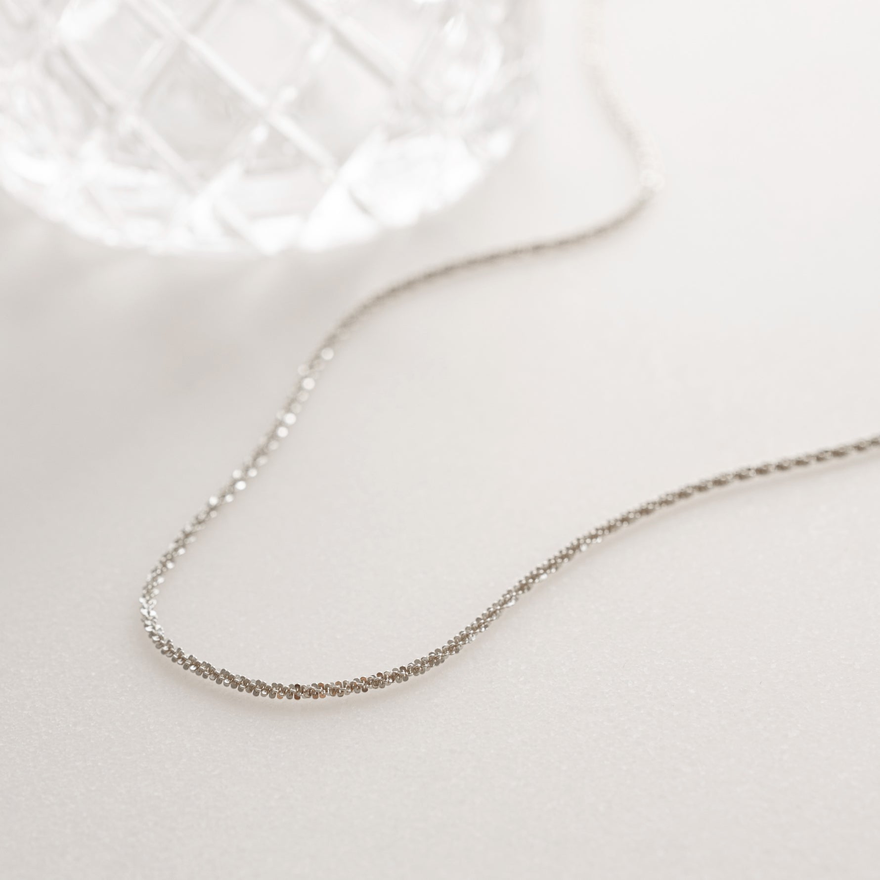 Silver diamond cut necklace in soft white lighting