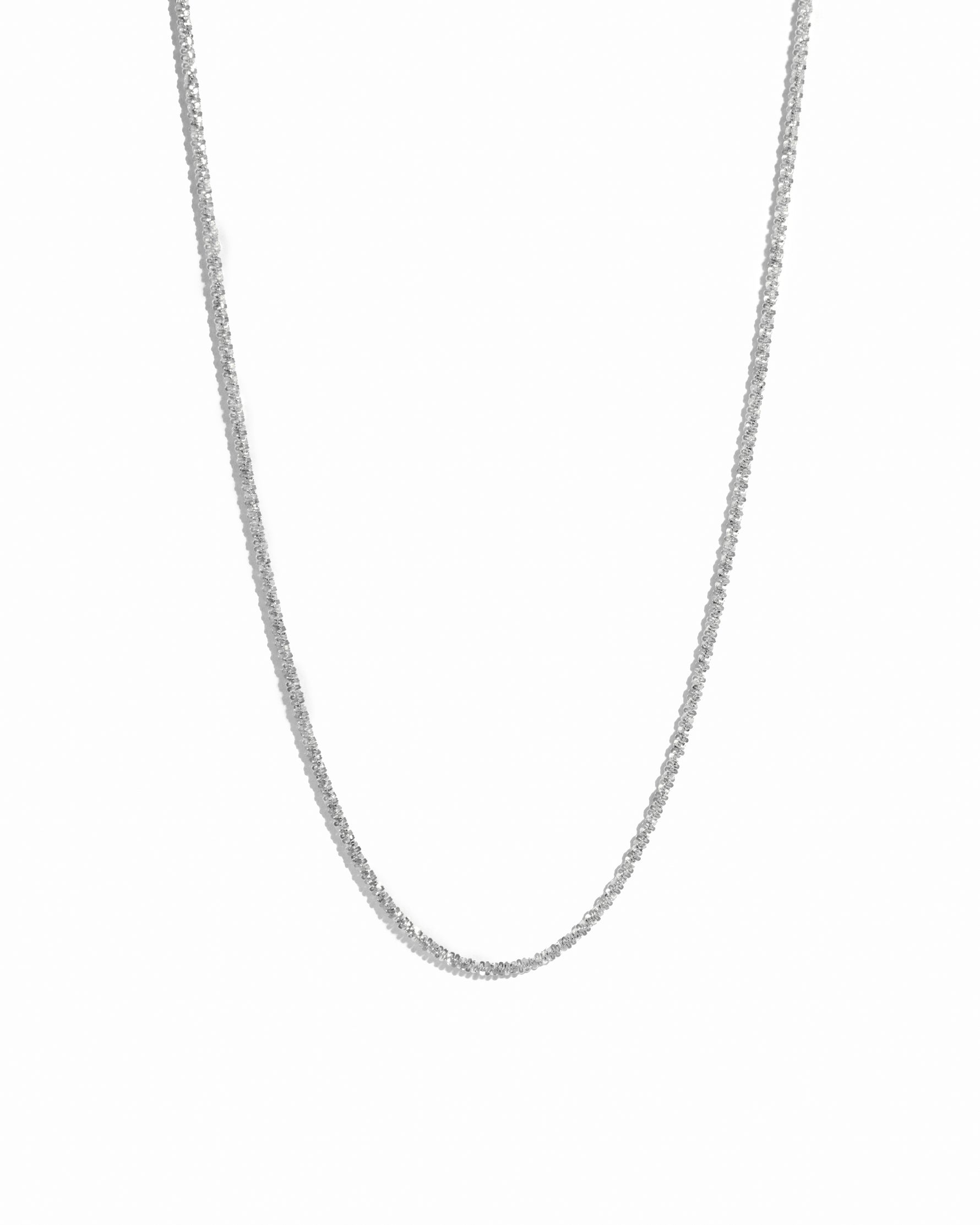 Silver diamond cut chain necklace on white background