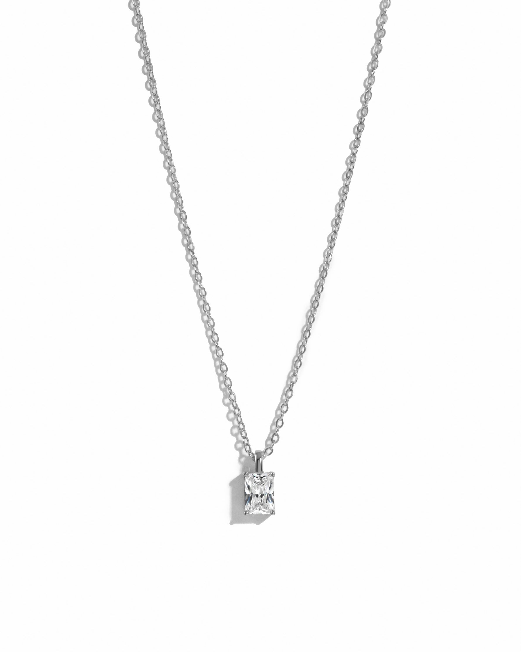 minimalist sterling silver cz necklace on white background