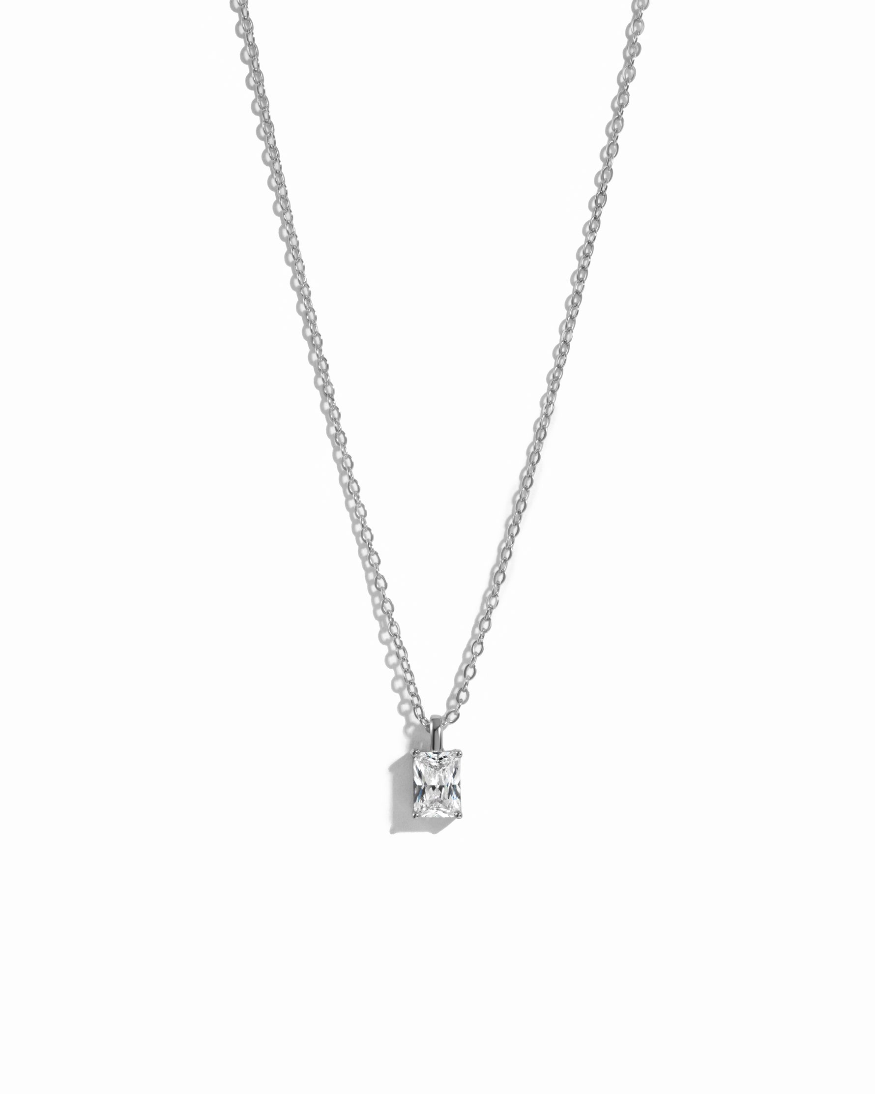 minimalist sterling silver cz necklace on white background