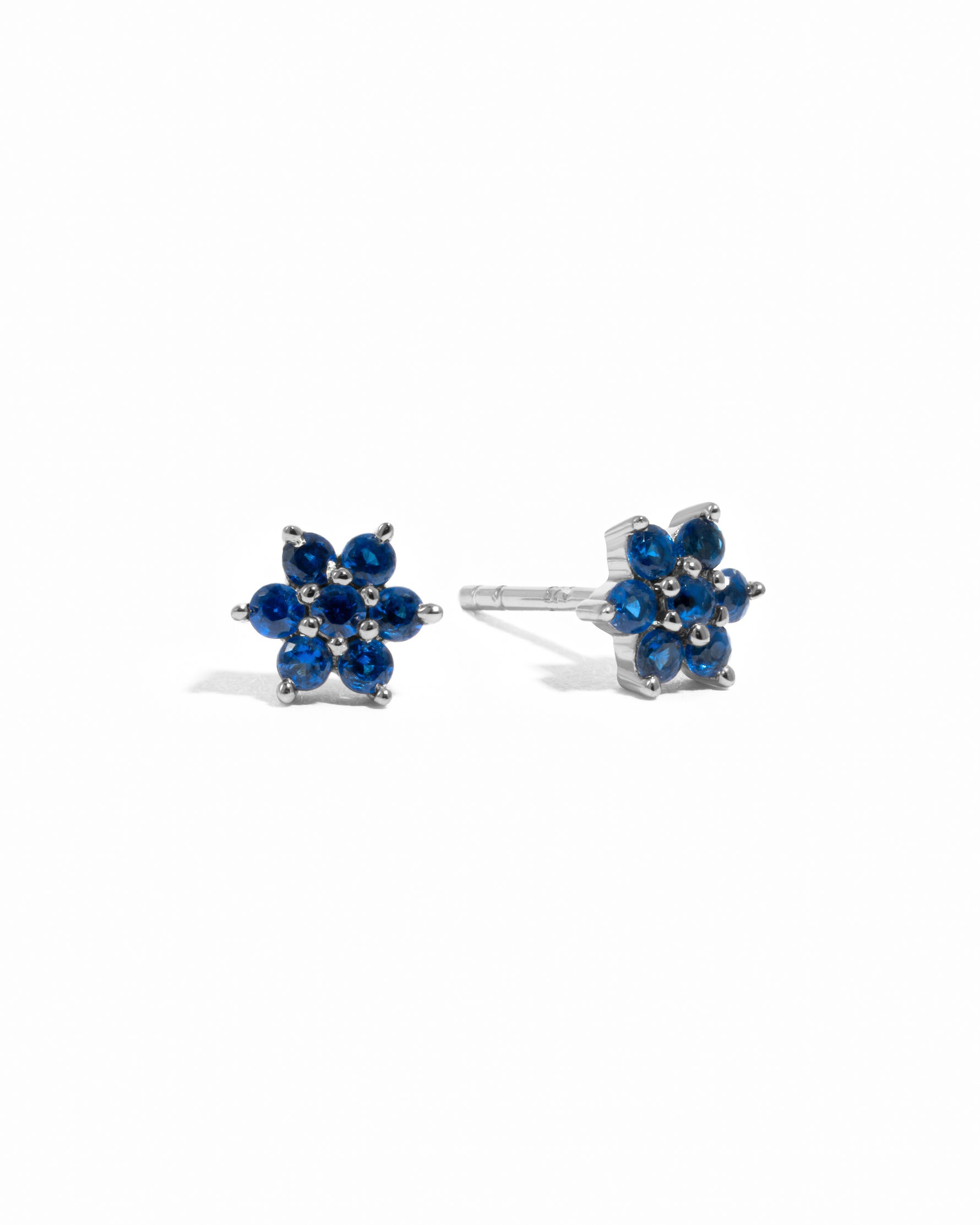 Solid sapphire gemstone flower stud earrings in sterling silver.