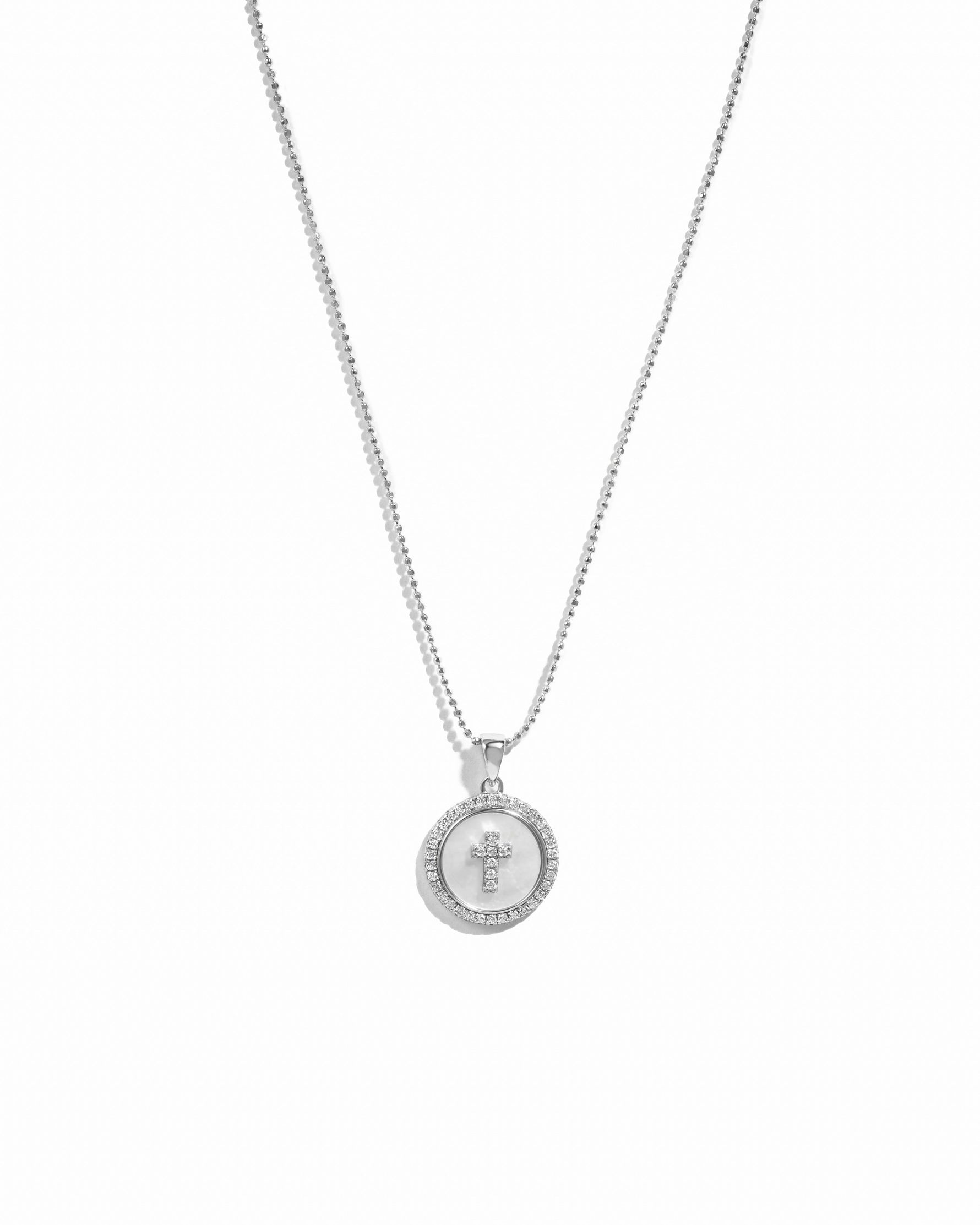 Sterling silver mother of pearl circle charm pendant necklace with cross.