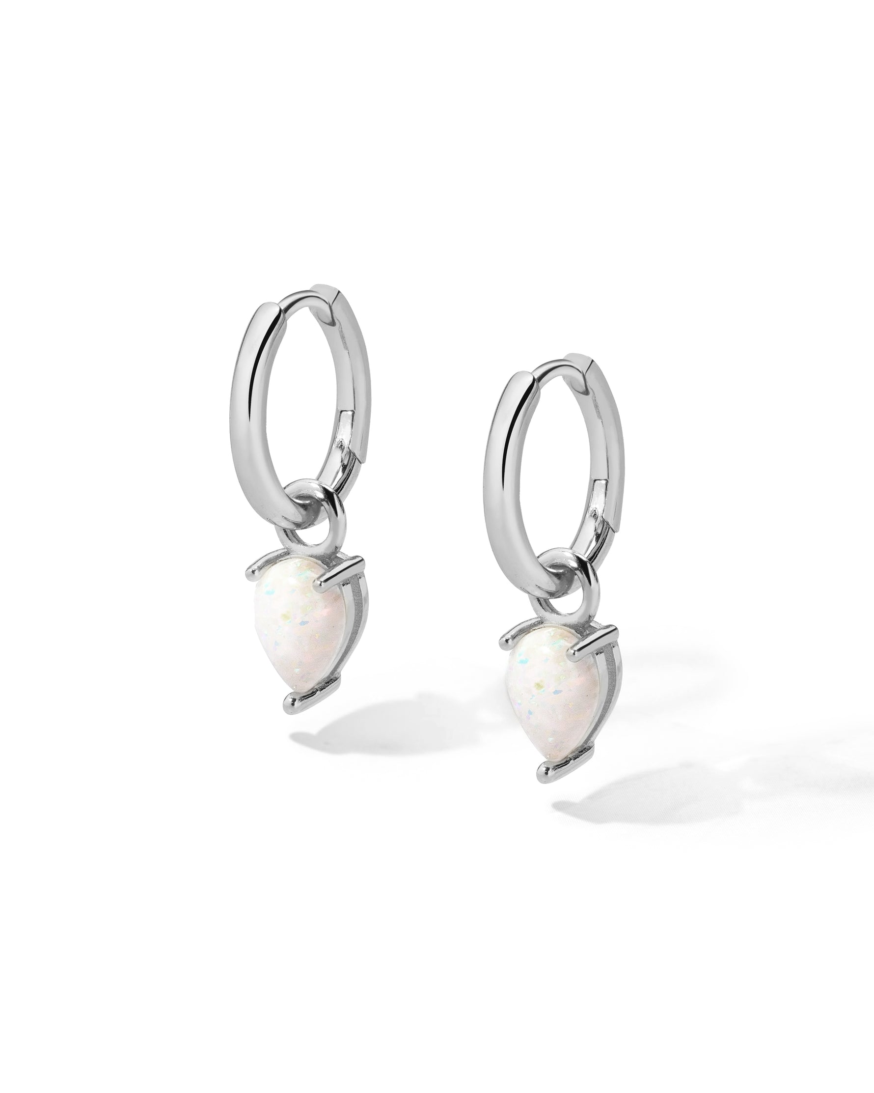 Sterling silver removable opal tear drop charm earrings on white background.