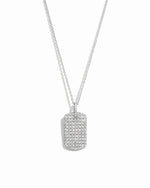 Silver pavé dog tag pendant necklace on white background.