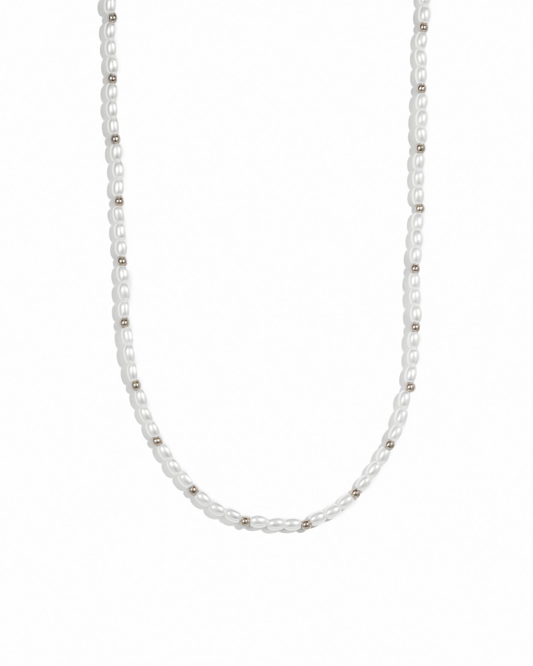 Silver beads and pearl beaded necklace on white background.