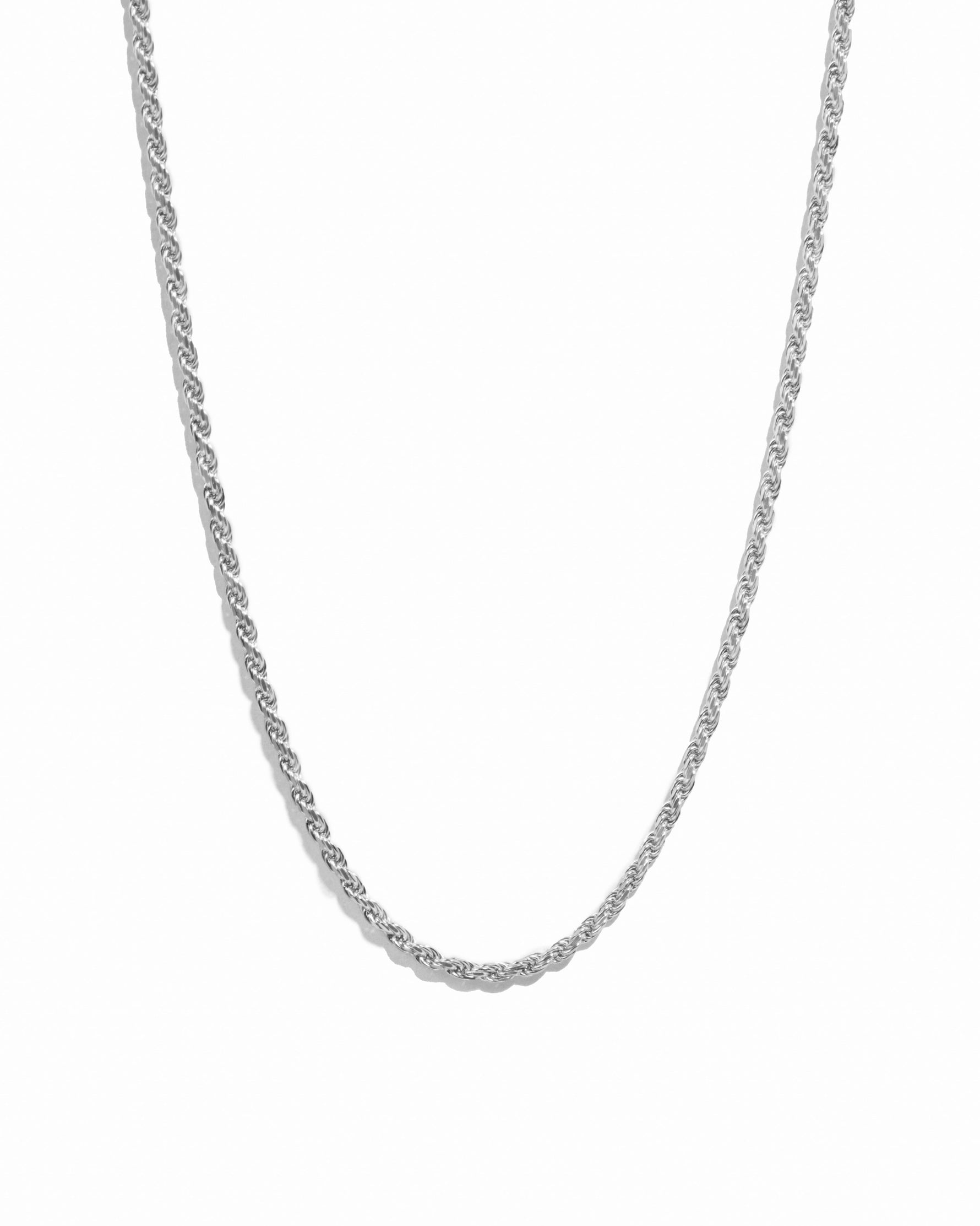 Silver thin rope chain necklace on white background