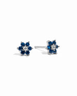 Sterling silver sapphire flower stud earrings with white cz center stone.
