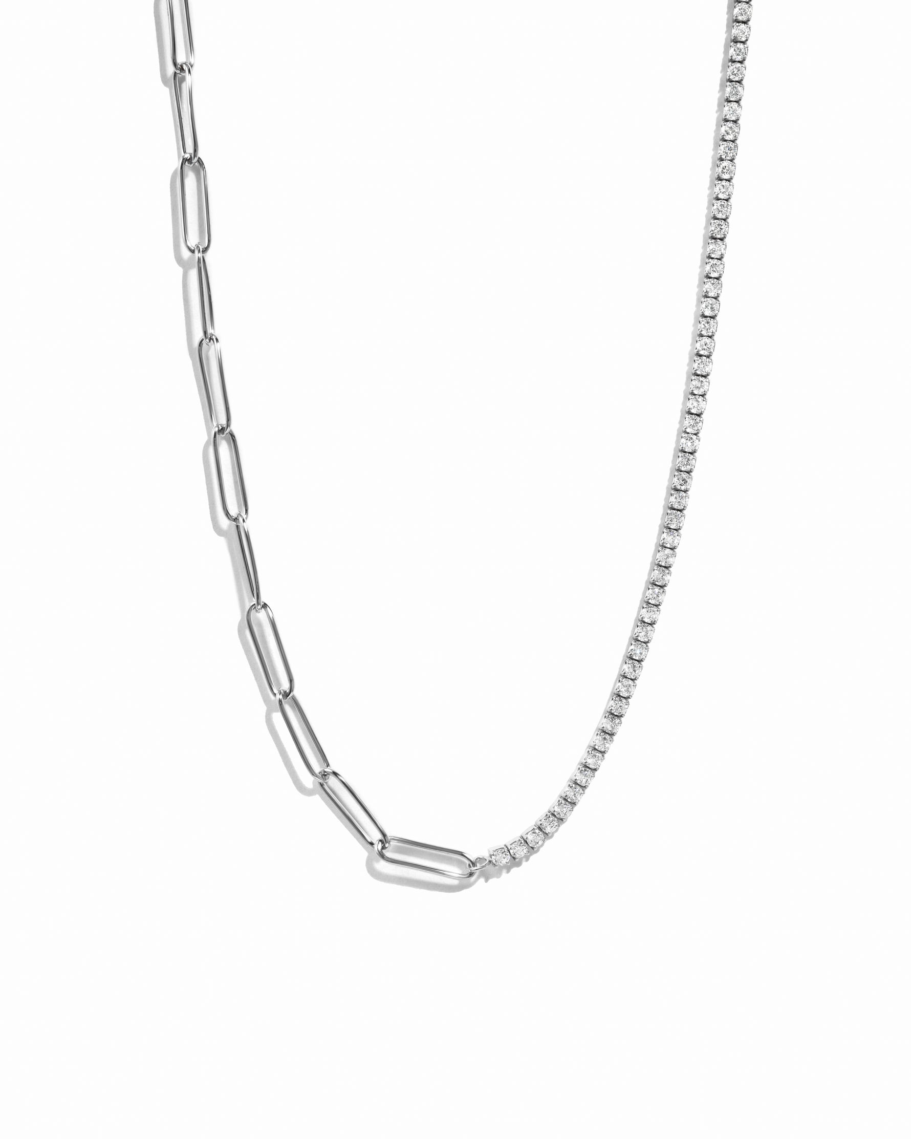 Silver half tennis half paperclip chain necklace on white background