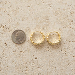 Gold croissant hoop earrings.