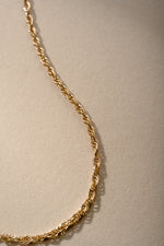 Up-close gold rope chain necklace.