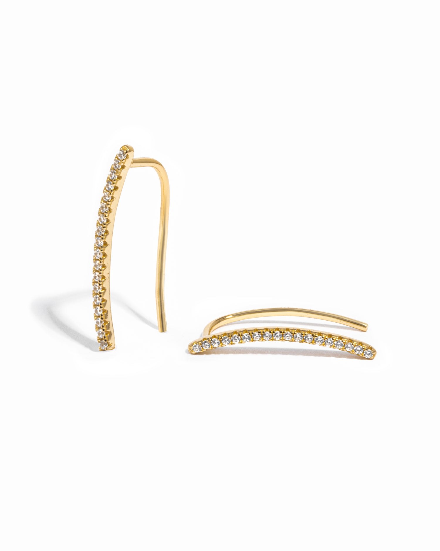 Delicate gold studded cz ear climber on white background.