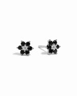 Sterling silver black gemstone stud earrings with white cz diamond center.