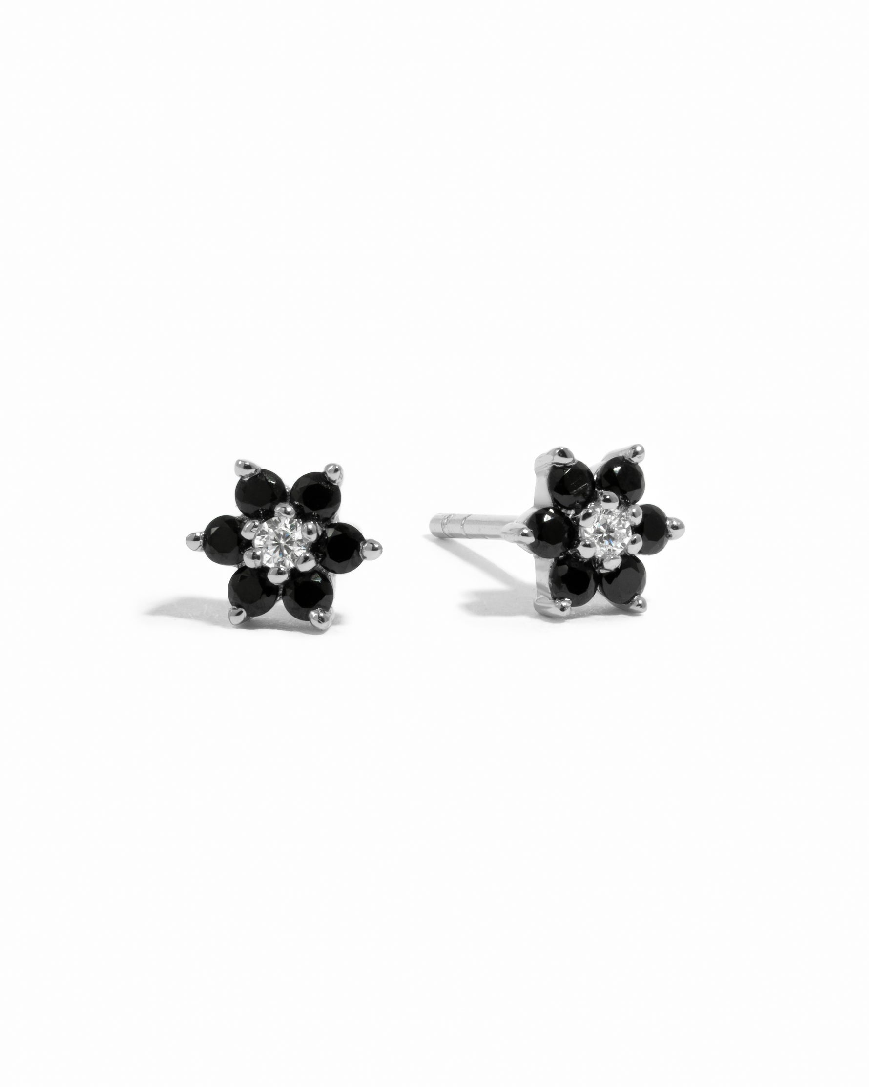 Sterling silver black gemstone stud earrings with white cz diamond center.