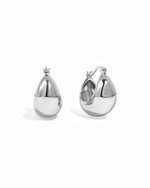Thick chunky silver basket hoop earrings on white background.