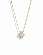 Close-up of four leaf clover pendant inspired by Van Cleef, highlighting intricate diamond details of pear shaped stones made of cubic zirconia.