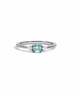 Aquamarine cushion diamond ring on white background in sterling silver.