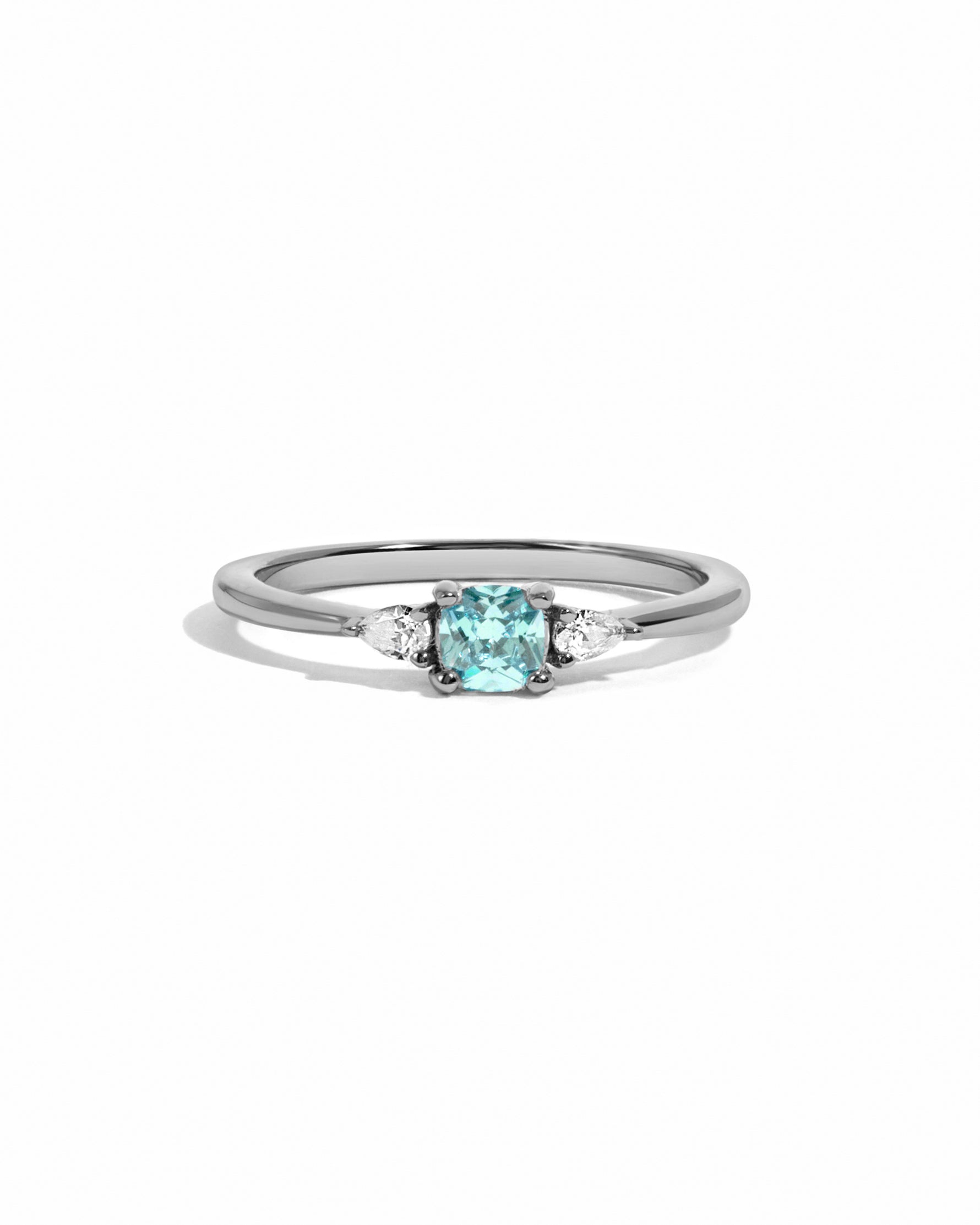 Aquamarine cushion diamond ring on white background in sterling silver.