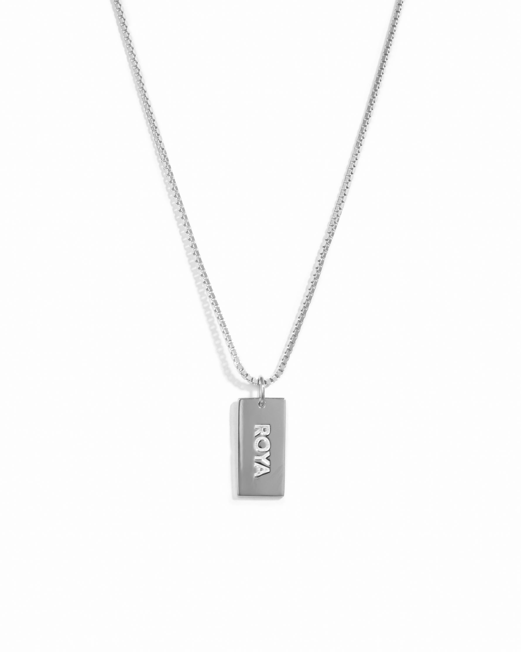 Sterling silver dainty dog tag customizable necklace on a box chain with a name on it.