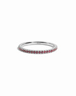 Sterling silver ruby eternity ring on white background.