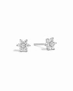 Sterling silver dainty diamond cz flower stud earrings on white background.