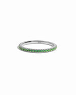Sterling silver emerald eternity ring on white background. 