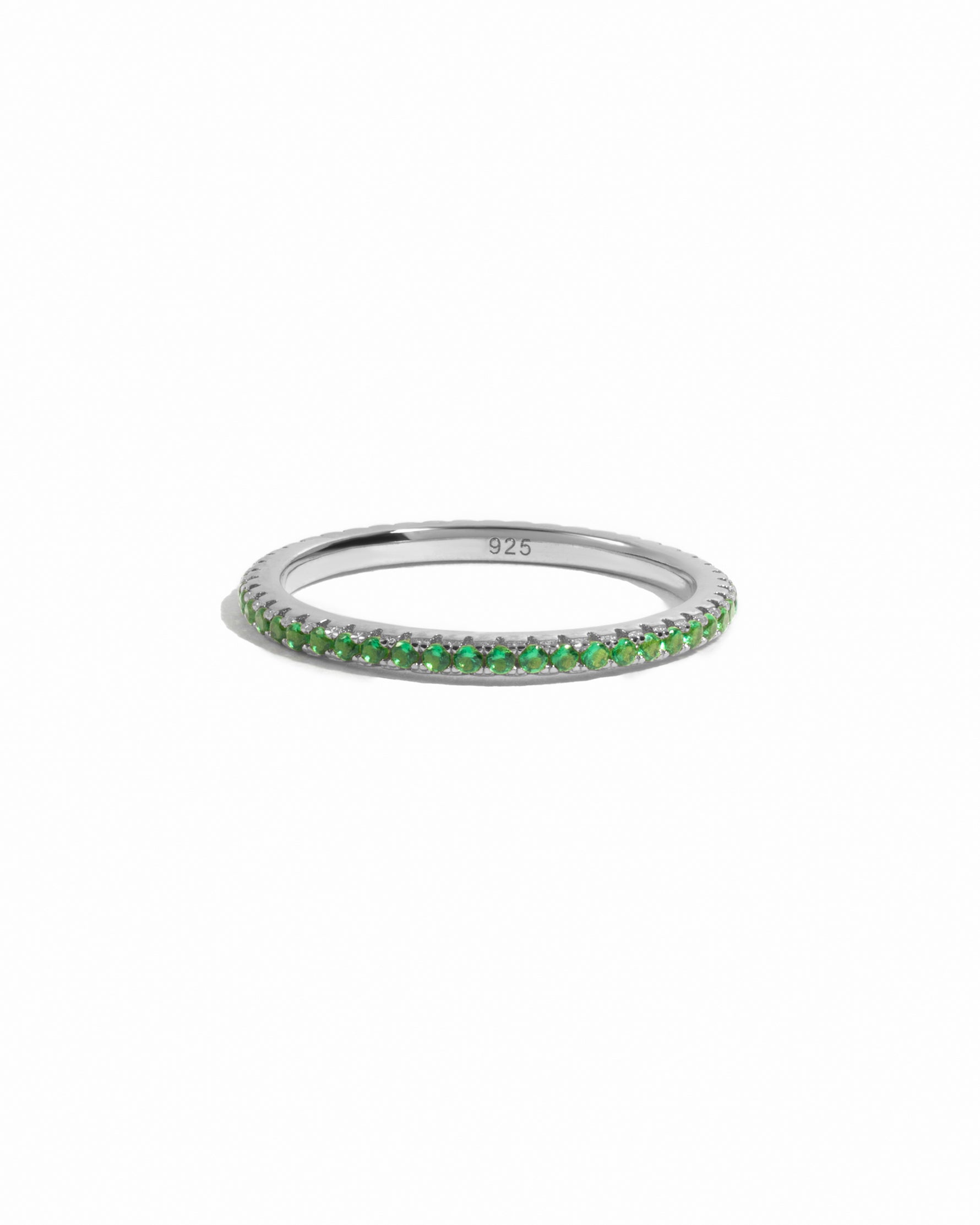 Sterling silver emerald eternity ring on white background. 