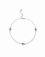 Delicate silver evil eye charm ankle bracelet with sapphire center.