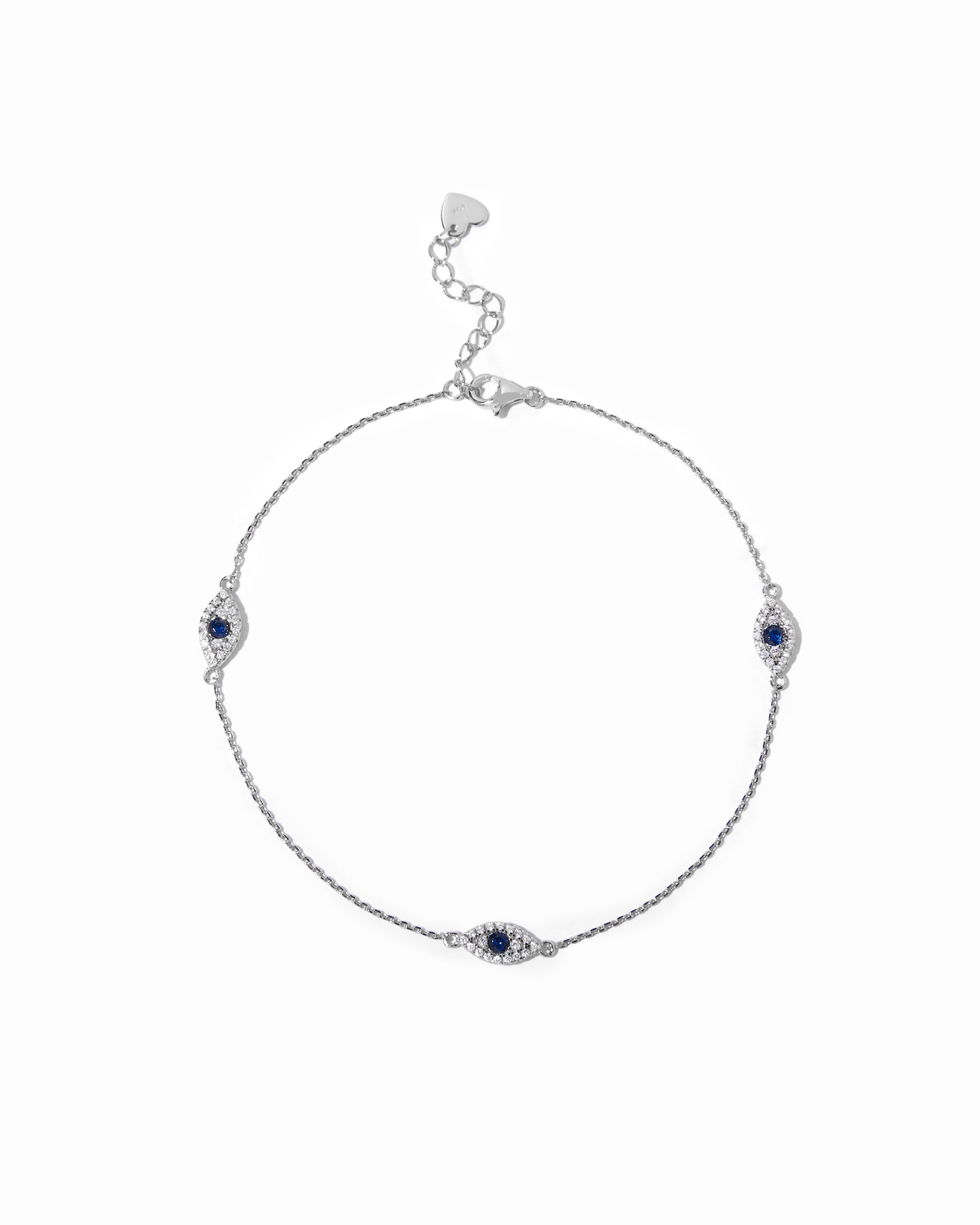 Delicate silver evil eye charm ankle bracelet with sapphire center.