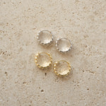 Gold and silver croissant textured hoop earrings. 
