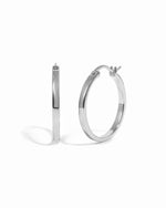 Silver hoop earrings on a white background