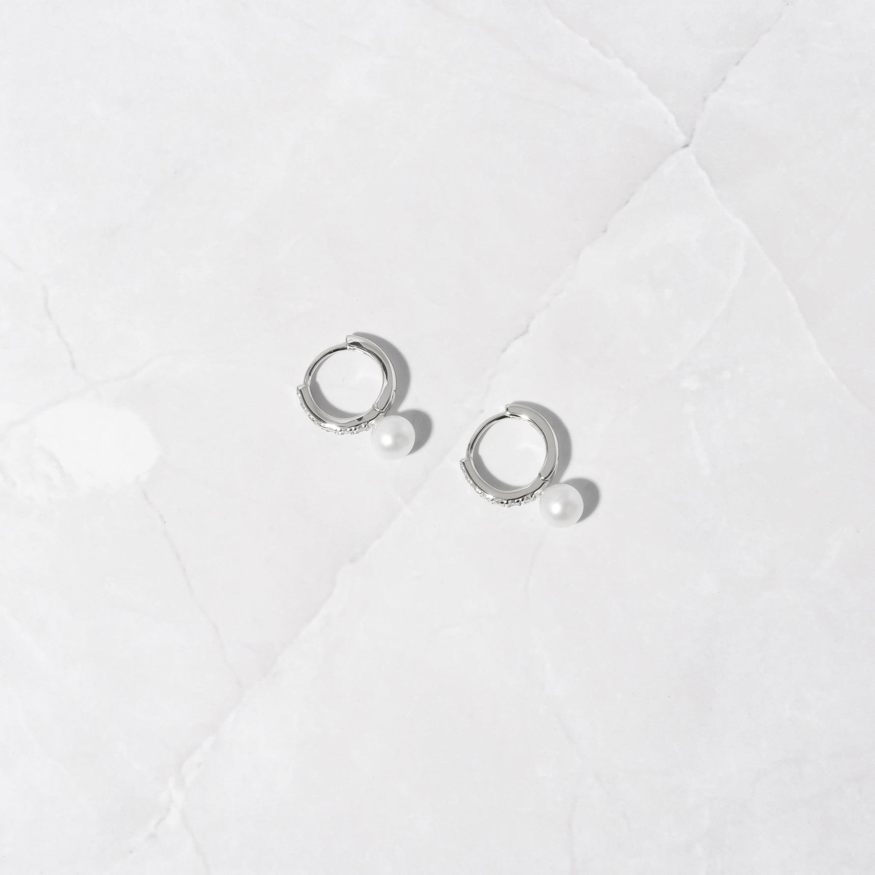 Sterling silver pearl charm diamond hoop earrings. 