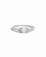 Sterling silver dainty opal birthstone ring with cz stones on white background. 
