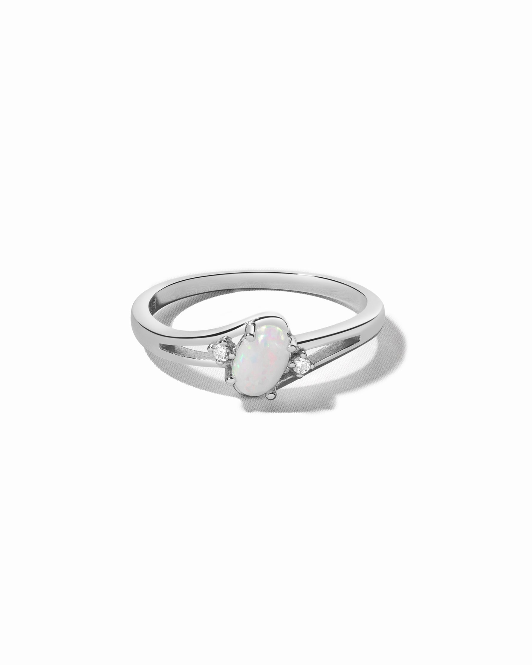 Sterling silver opal oval ring with cubic zirconia side stones.