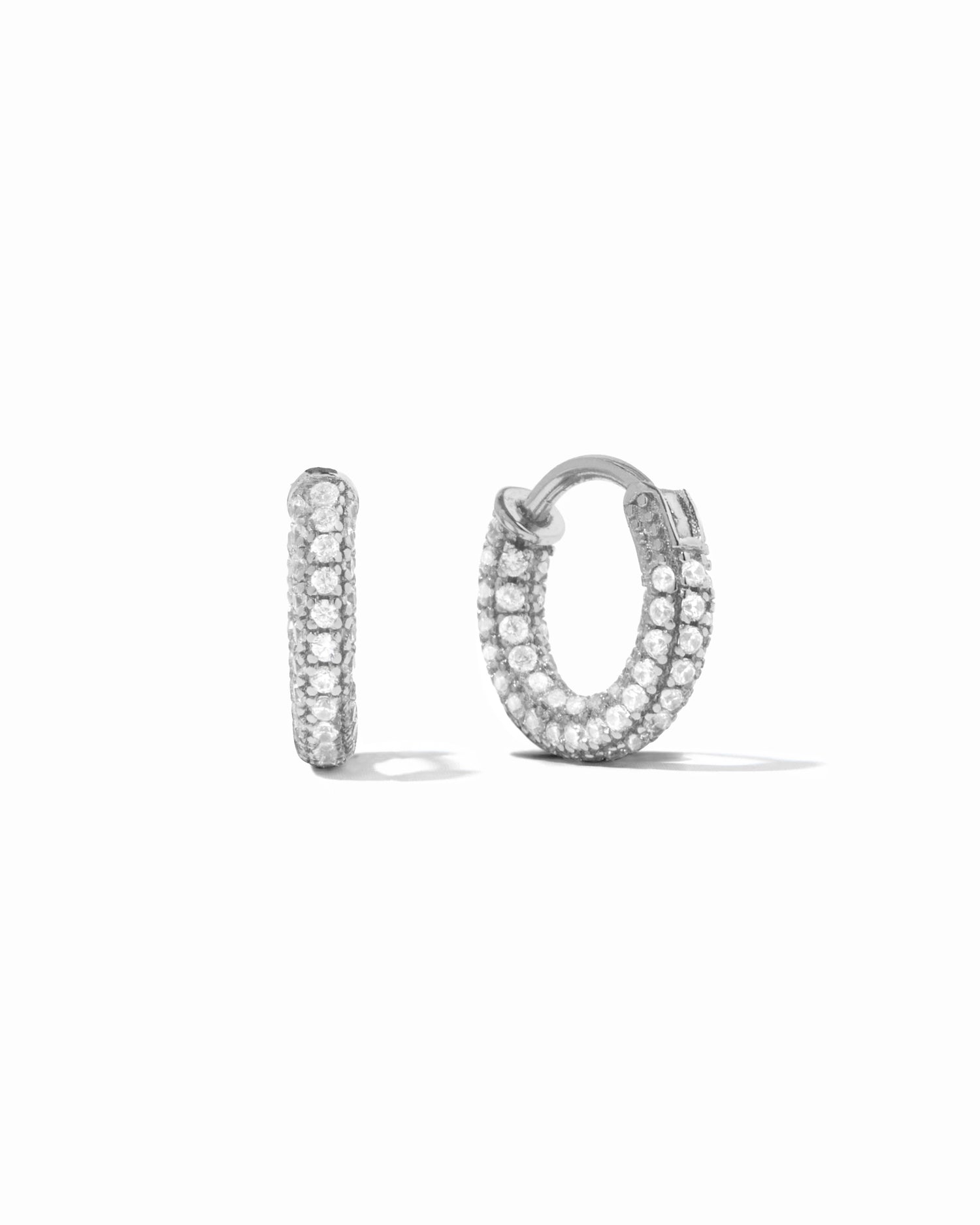 Small pavé sterling silver hoop earrings on white background.