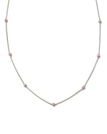 Silver pavé ruby beaded ball necklace on white background