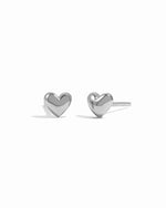 Sleek small sterling silver heart stud earrings on white background