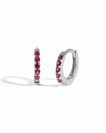Sterling silver birthstone ruby huggie earrings.