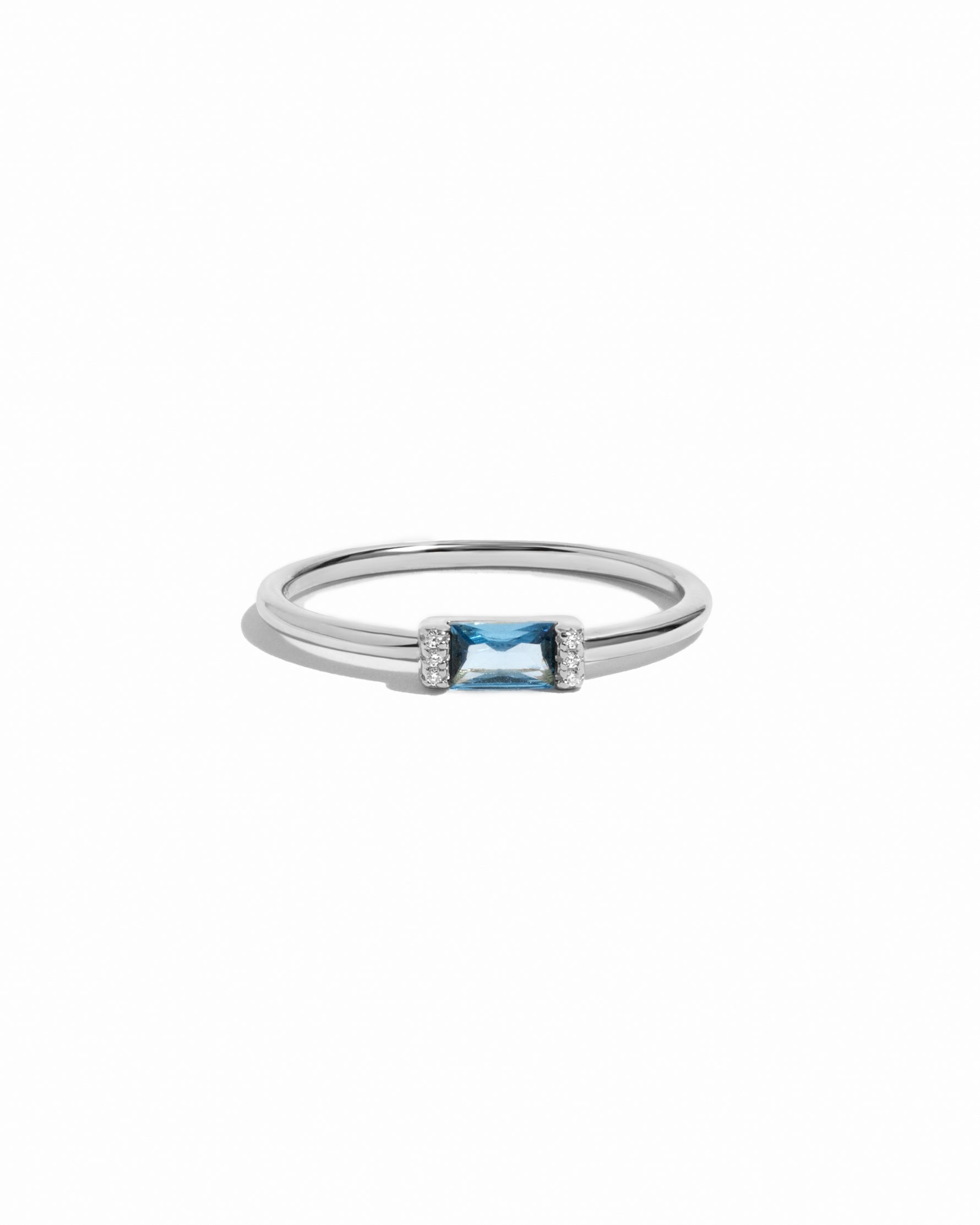 Timeless sterling silver aquamarine birthstone ring on white background.
