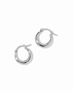 Dainty sterling silver basket huggie hoop earrings on white background.