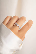 Model wearing classy silver split shank round diamond ring. 