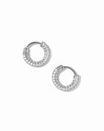 Sterling silver diamond studded circular hoop earrings on white background.