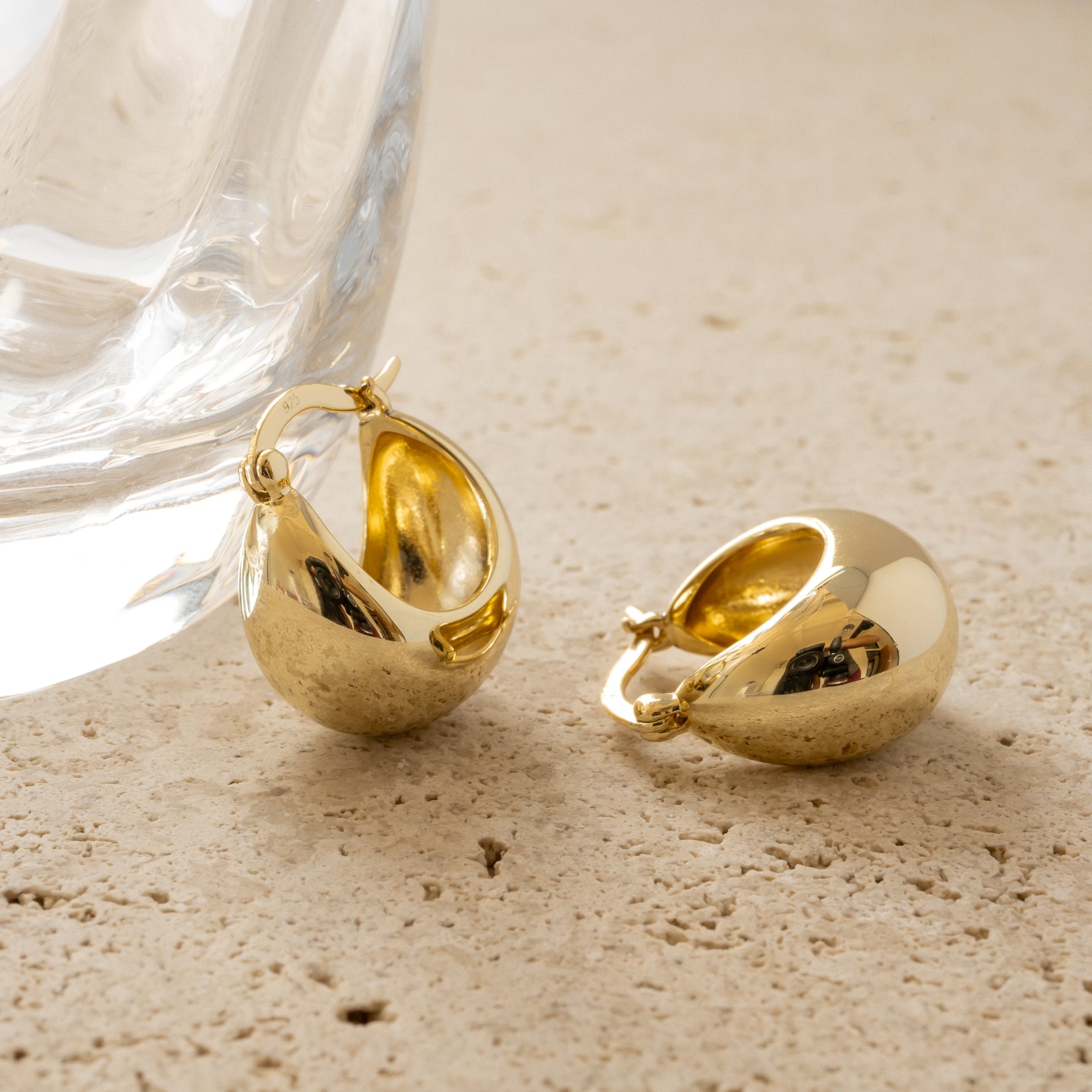 Gold tube hoop earrings.