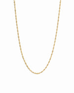 Thin gold twisted chain necklace on white background