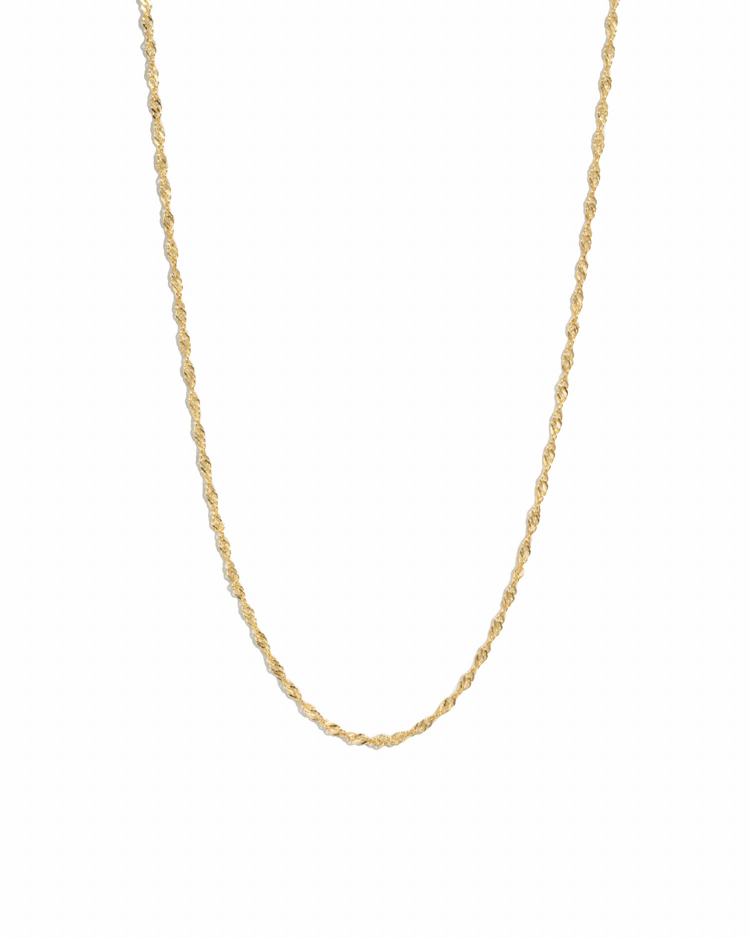 Thin gold twisted chain necklace on white background