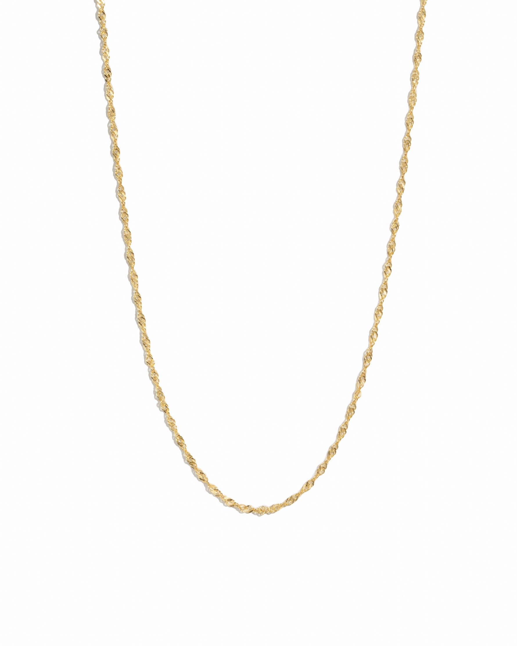 Thin gold twisted chain necklace on white background