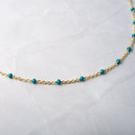 Up-close of turquoise beaded chain necklace. 